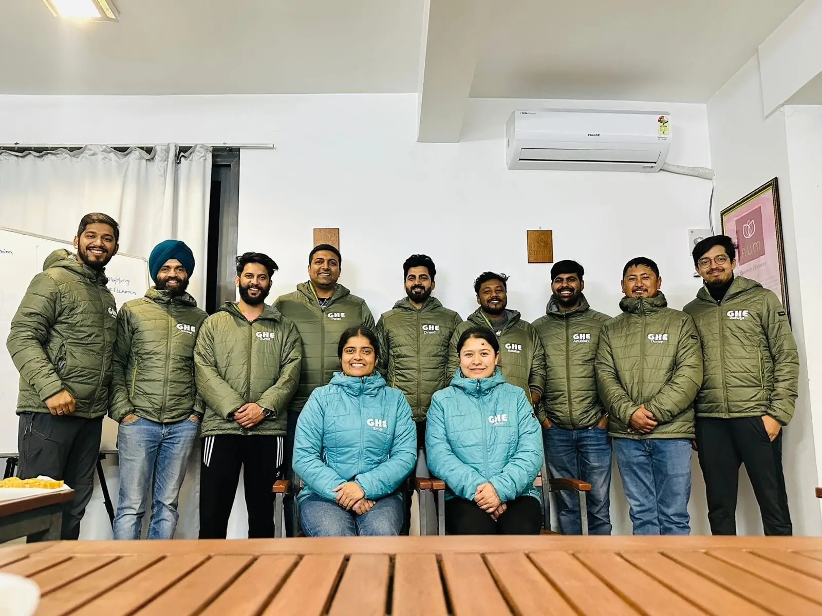 Corporate group photo indoors during an offsite at Atali Ganga