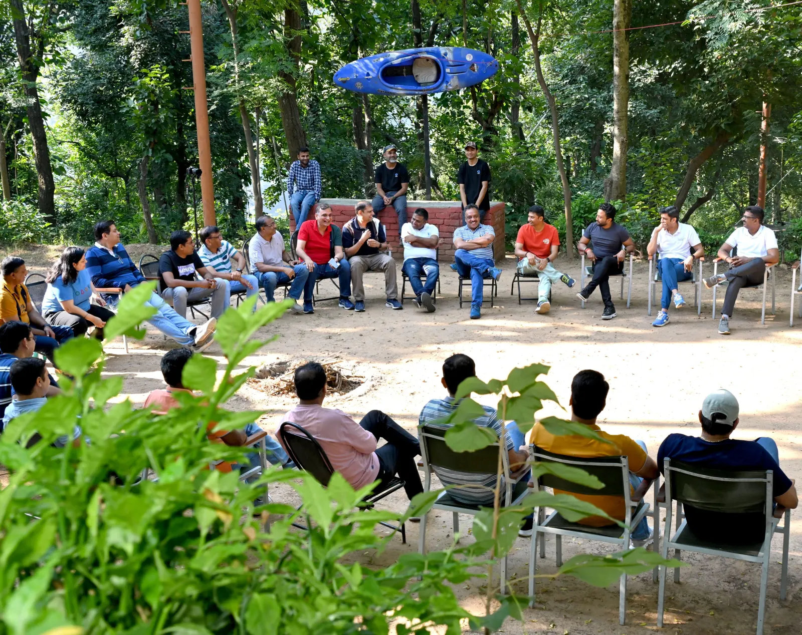 Corporate group in a circle discussion outdoors at Atali Ganga