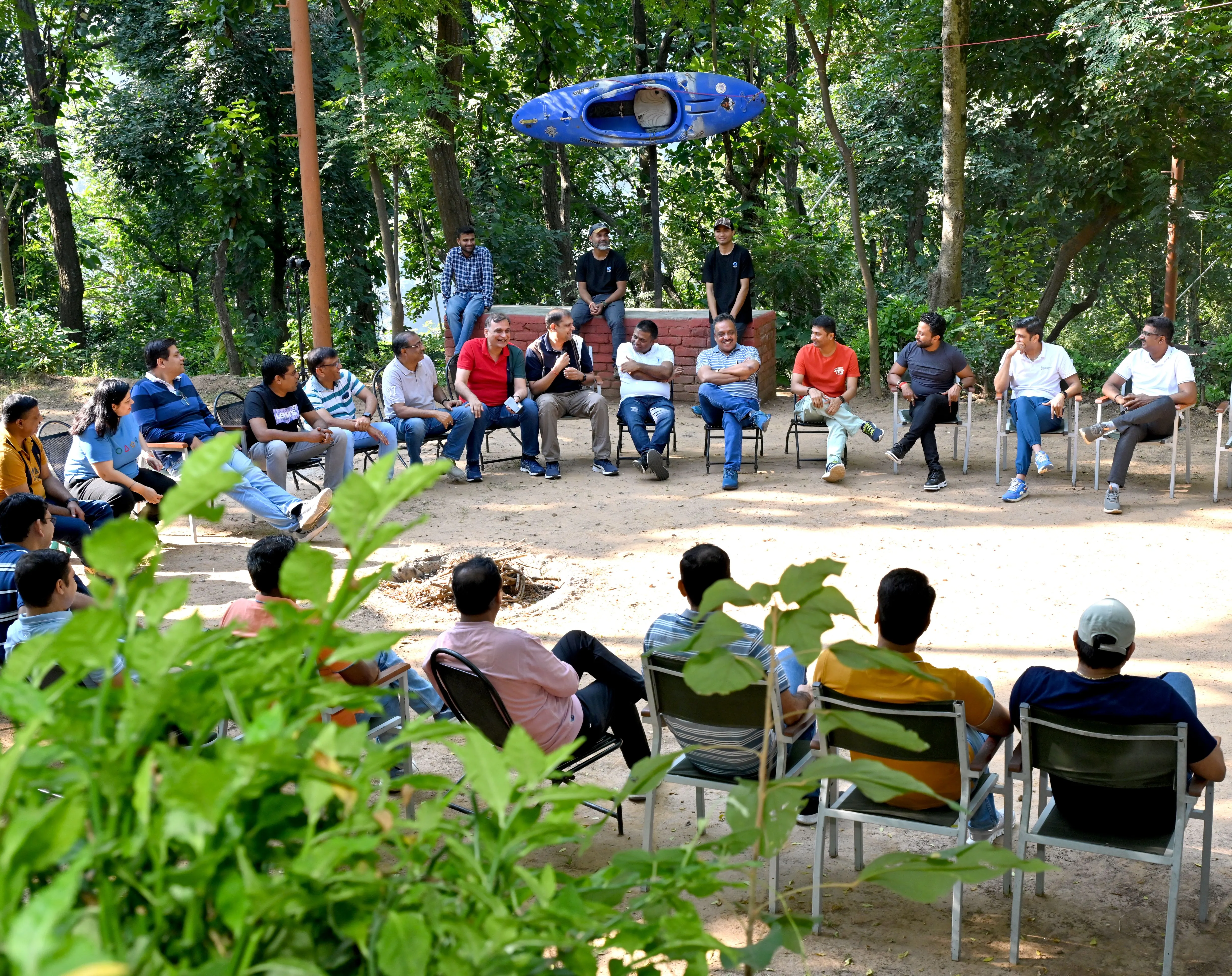 Corporate group in a circle discussion outdoors at Atali Ganga