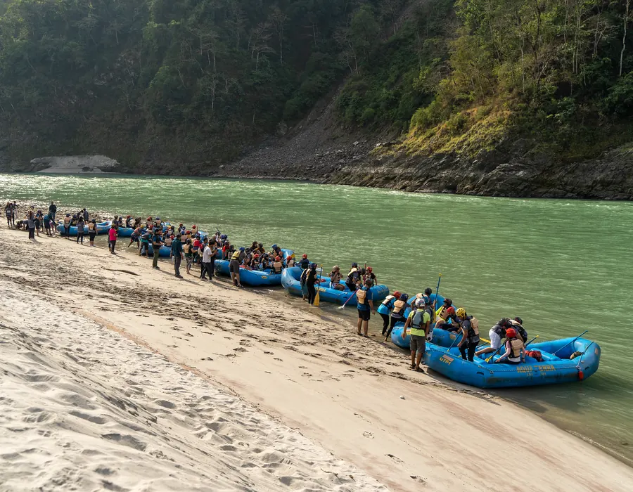Rafts lined up on the beach before a student rafting session