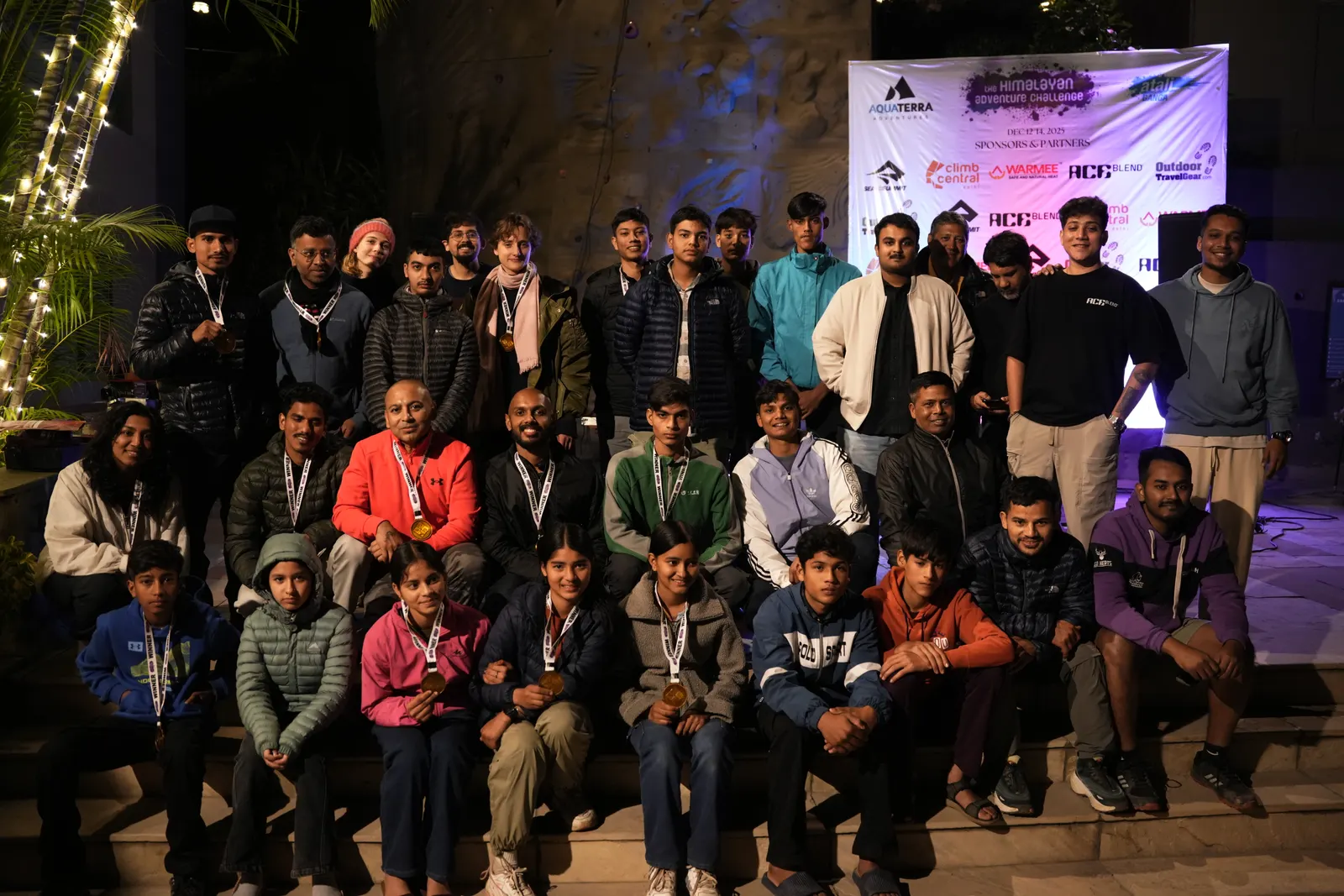 Himalayan Adventure Challenge participants and organizers group photo with sponsor banner